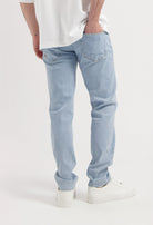Sustainable MUD Jeans in black denim, showcasing ethical fashion with classic back pockets and minimalist design.